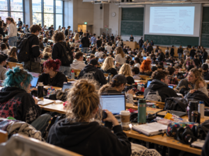 Voller Hörsaal mit Studierenden als Beispiel für Reizüberflutung beim Studieren mit Autismus